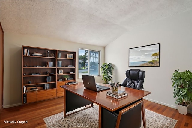 office with baseboards, a textured ceiling, lofted ceiling, and wood finished floors