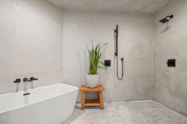 bathroom featuring a tile shower and a freestanding bath