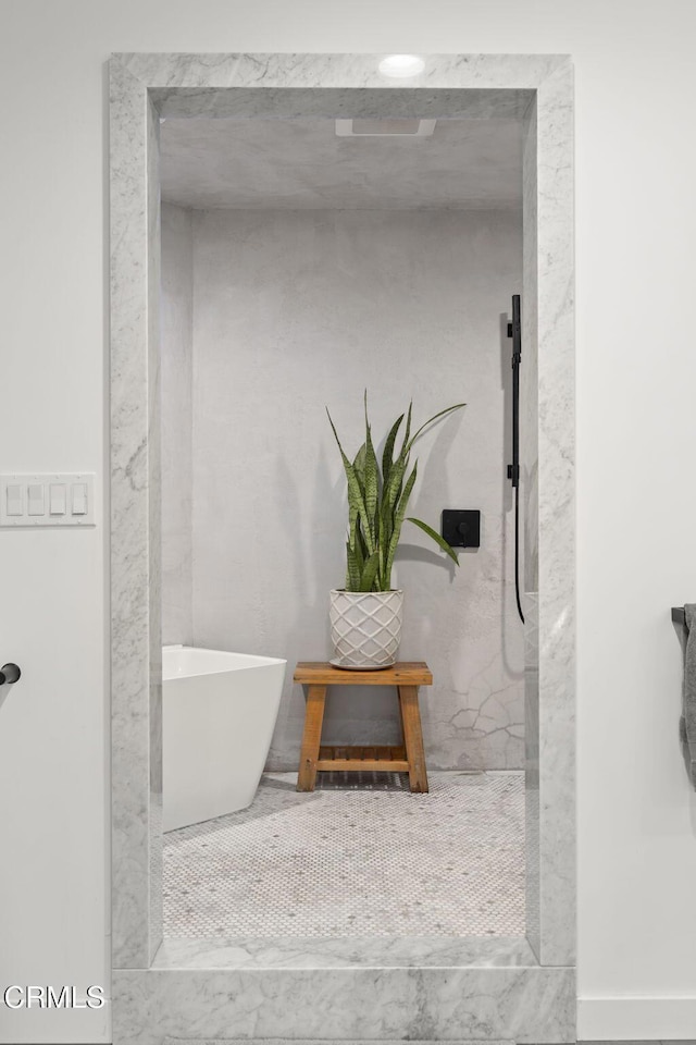 bathroom featuring a soaking tub