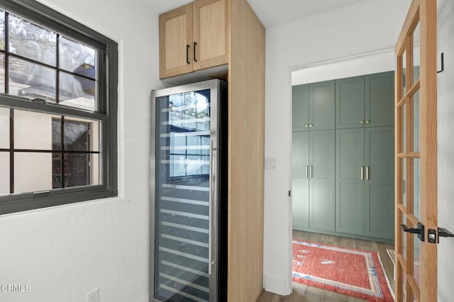 doorway featuring beverage cooler and wood finished floors