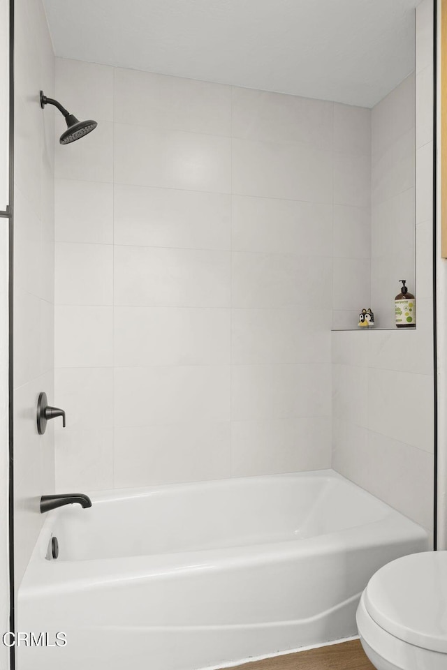 bathroom featuring toilet and shower / washtub combination