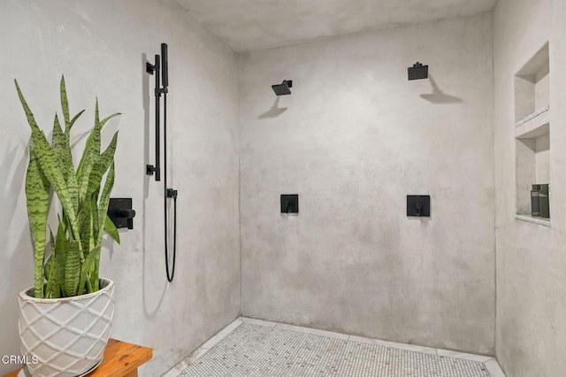 bathroom featuring tile patterned flooring and a tile shower