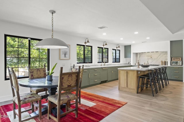 dining room featuring recessed lighting, light wood-style floors, and visible vents
