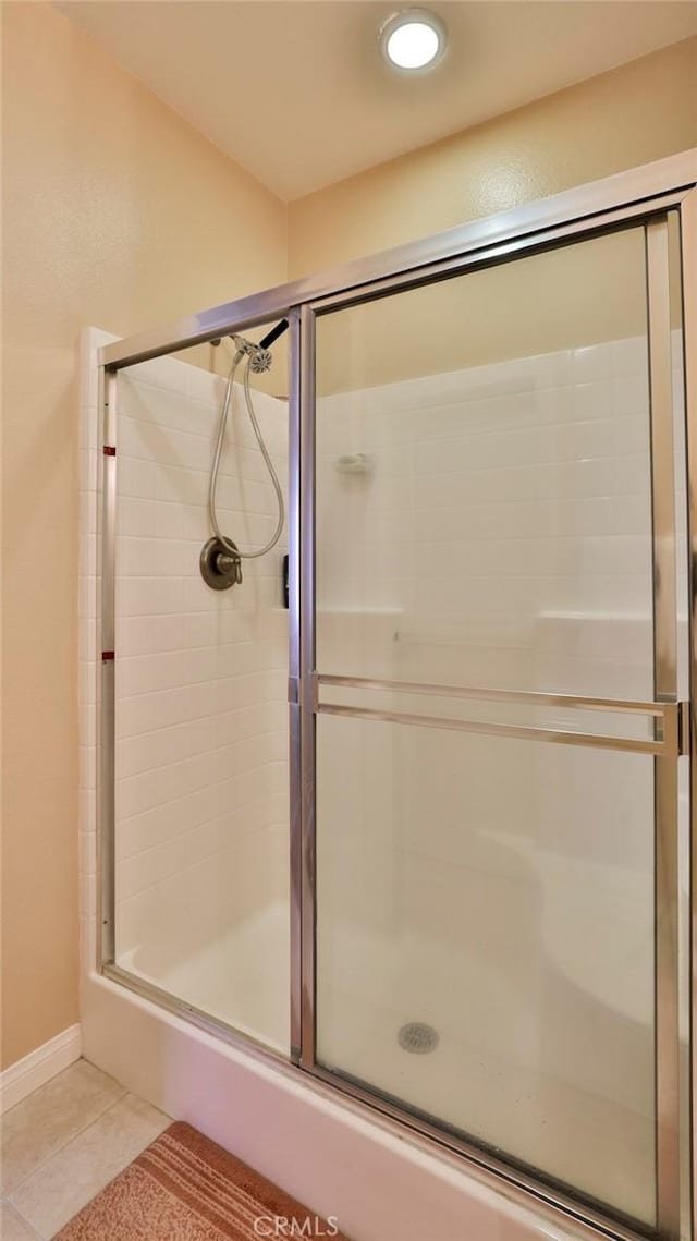 full bathroom featuring a stall shower and tile patterned floors