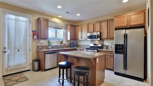 kitchen featuring a breakfast bar area, recessed lighting, visible vents, appliances with stainless steel finishes, and a center island