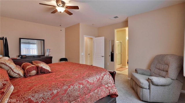 carpeted bedroom featuring a ceiling fan, visible vents, and connected bathroom