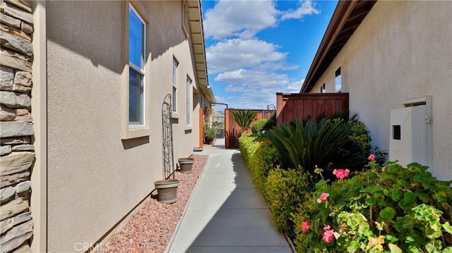 view of home's exterior with fence and stucco siding