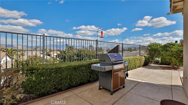 view of patio featuring grilling area and fence