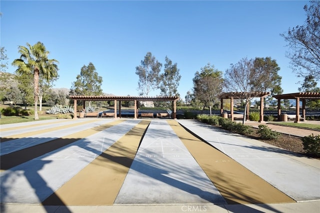 surrounding community featuring shuffleboard and a pergola