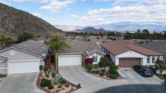 ranch-style house with driveway and a tiled roof