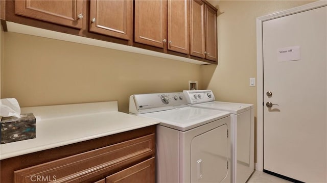 washroom featuring cabinet space and independent washer and dryer