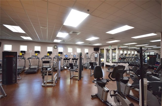 exercise room featuring a paneled ceiling and visible vents