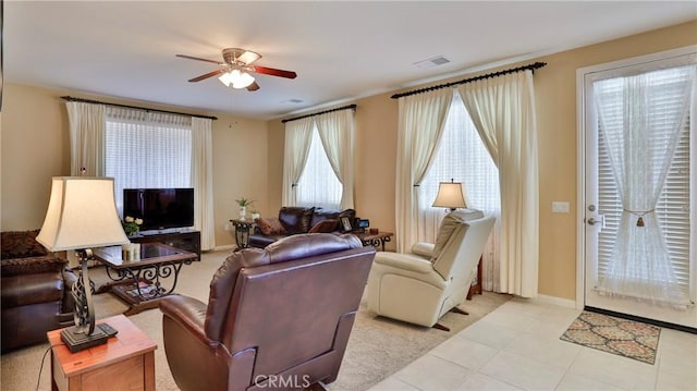 living room featuring a ceiling fan, visible vents, and baseboards