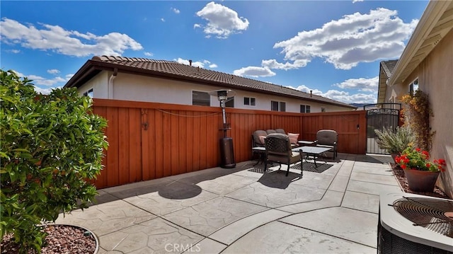 view of patio / terrace featuring outdoor lounge area, a fenced backyard, and a gate