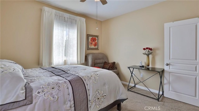 carpeted bedroom with baseboards and a ceiling fan