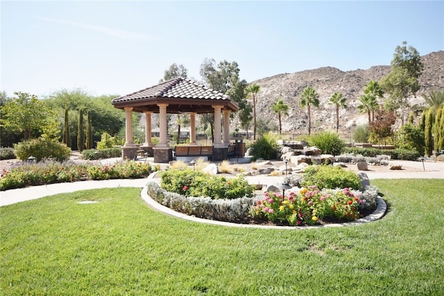 surrounding community with a yard, a gazebo, and a mountain view