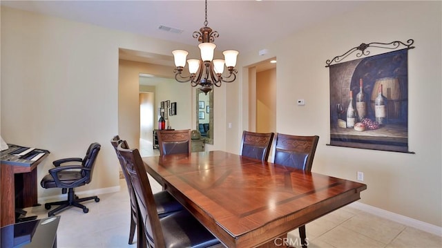 dining area featuring a chandelier, light tile patterned floors, visible vents, and baseboards