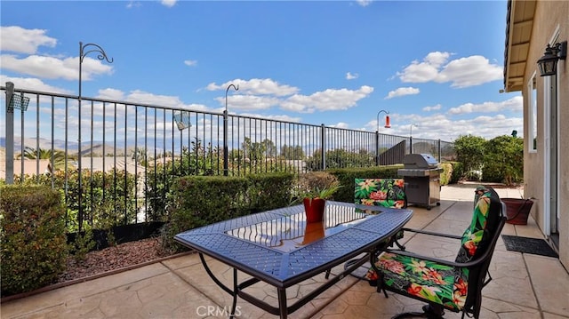 view of patio / terrace with fence, grilling area, and outdoor dining space