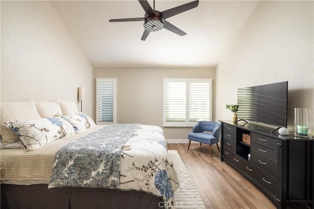 bedroom with light wood finished floors, ceiling fan, and lofted ceiling