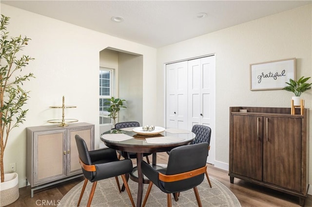 dining room with dark wood finished floors, recessed lighting, and baseboards