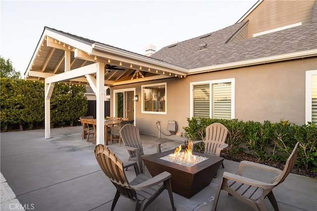 view of patio with outdoor dining area and an outdoor fire pit