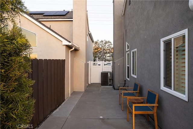 view of patio / terrace featuring fence and central AC