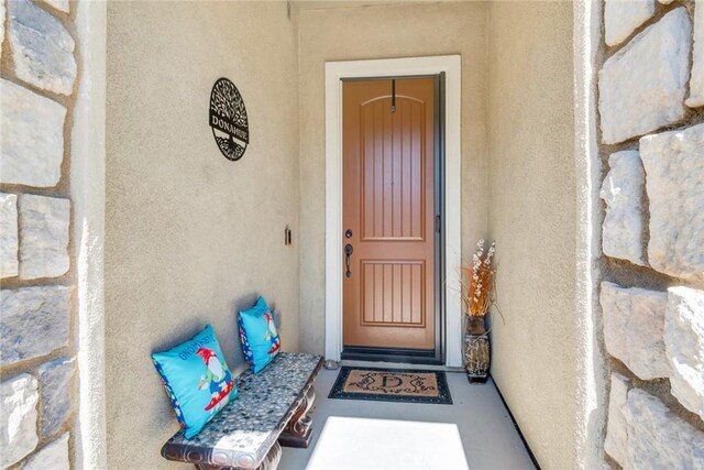 view of exterior entry with stucco siding