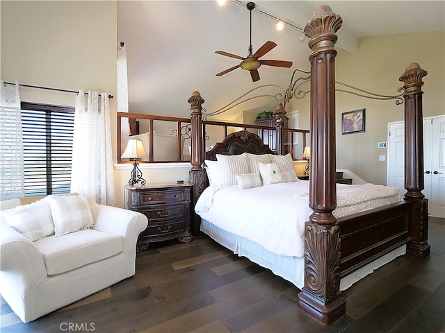 bedroom with high vaulted ceiling, dark wood finished floors, and decorative columns