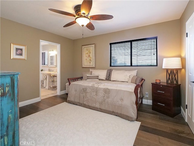 bedroom with a ceiling fan, dark wood-style flooring, baseboards, and ensuite bathroom