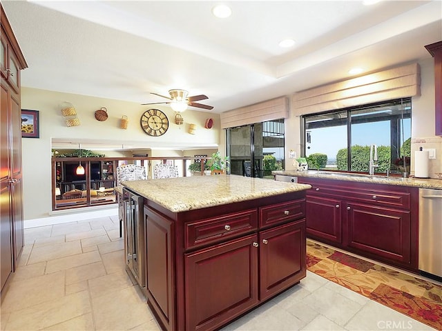 kitchen featuring wine cooler, a center island, recessed lighting, a sink, and dark brown cabinets