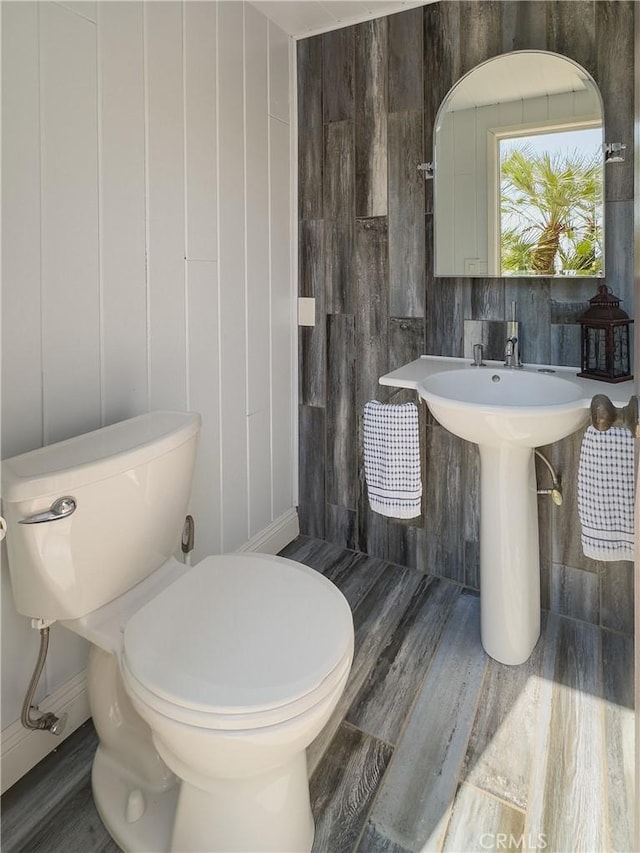 bathroom featuring toilet and wood finished floors