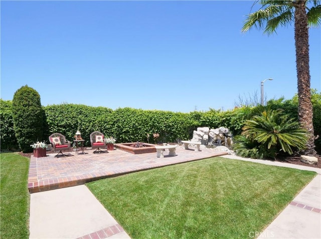 view of yard with an outdoor fire pit and a patio