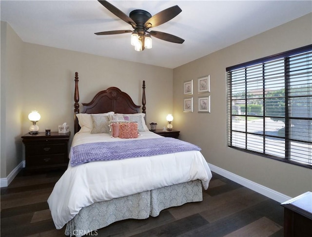 bedroom featuring a ceiling fan, baseboards, and wood finished floors