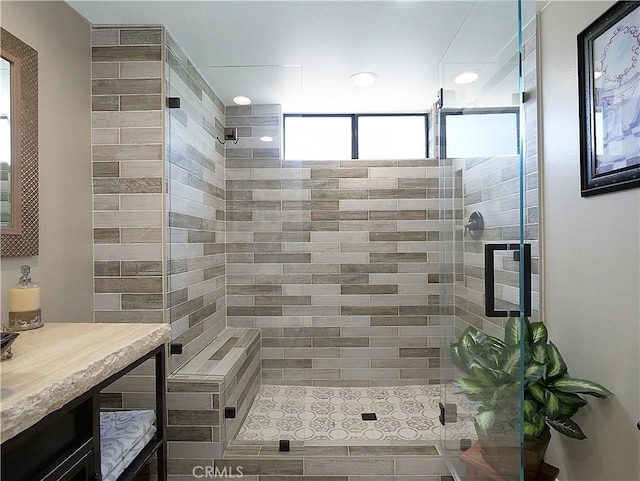 bathroom with a stall shower and vanity