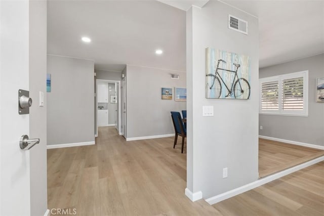 corridor featuring baseboards, visible vents, wood finished floors, and recessed lighting