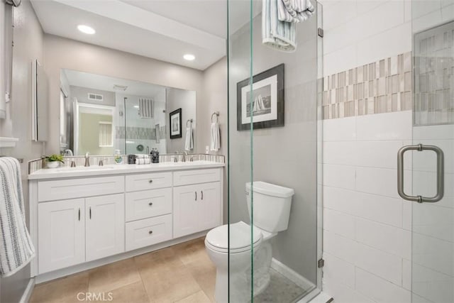 full bathroom featuring a stall shower, tile patterned flooring, and a sink