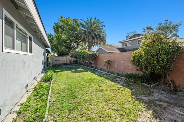 view of yard with a fenced backyard