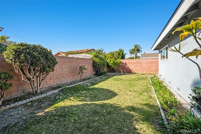 view of yard with a fenced backyard