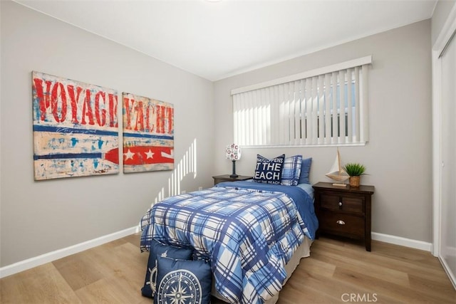 bedroom featuring baseboards and wood finished floors