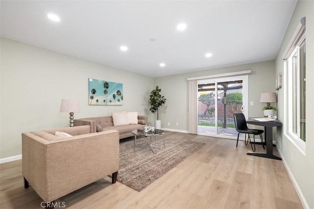 living area featuring recessed lighting, light wood-style flooring, and baseboards