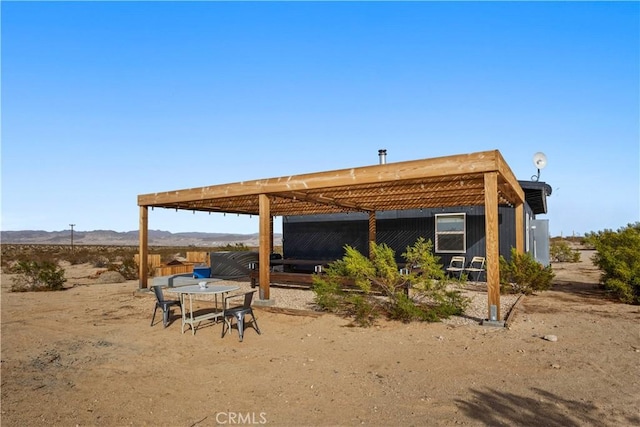 back of house with a mountain view