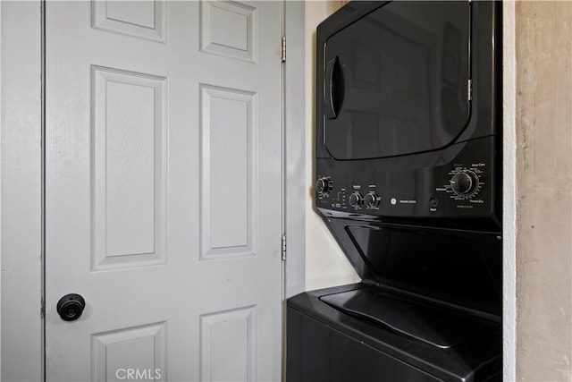 laundry area with laundry area and stacked washer / drying machine