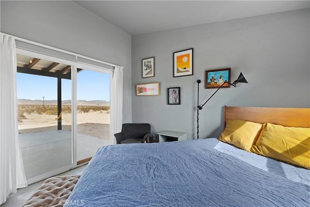 bedroom with access to outside and a mountain view