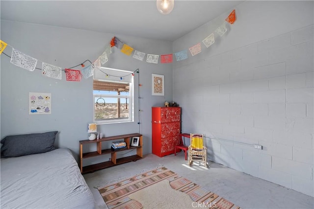 bedroom featuring unfinished concrete floors