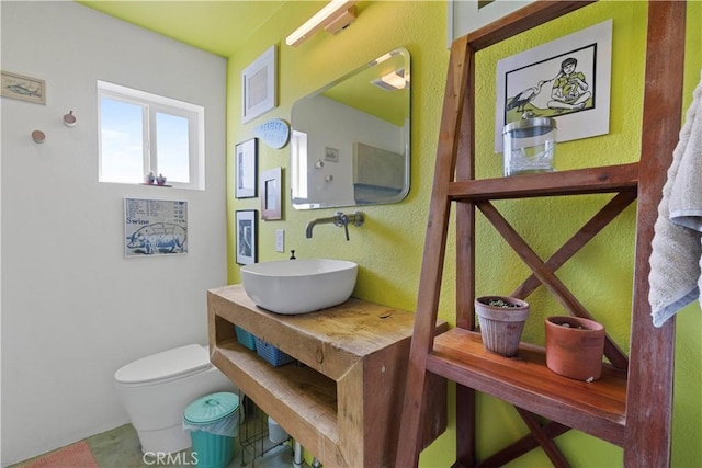 bathroom with visible vents, vanity, and toilet