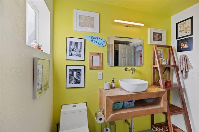 half bath featuring a sink and toilet