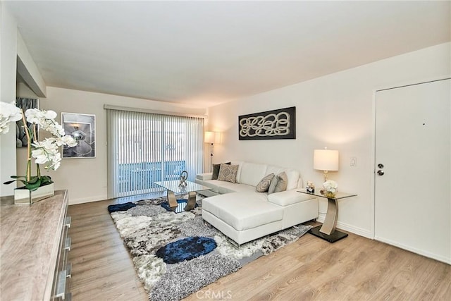 living area featuring wood finished floors and baseboards