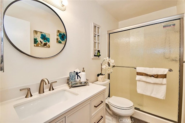 full bathroom with toilet, a stall shower, and vanity