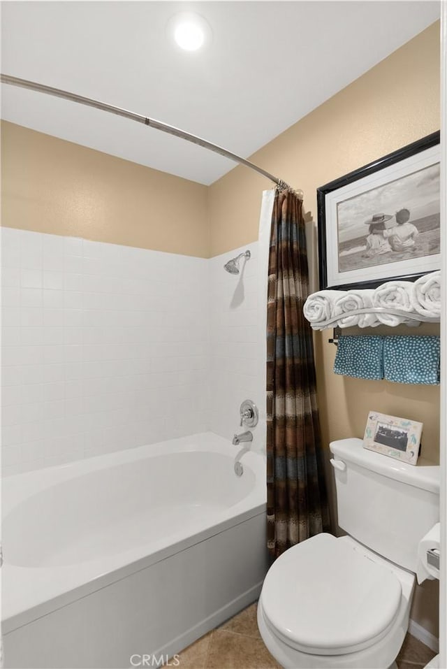 bathroom with shower / bath combo, tile patterned flooring, and toilet