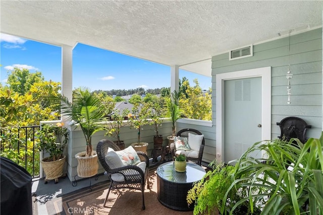 balcony with a grill and visible vents